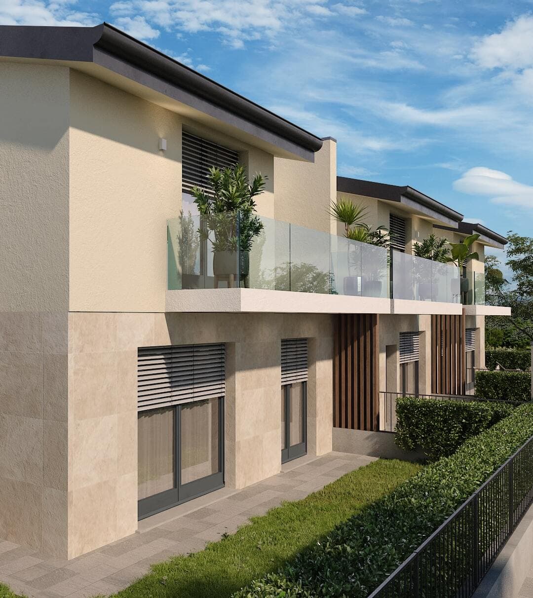 Residenze Le Ortensie a Pozzo d’Adda: scorcio della facciata con balconi in vetro e giardini privati
