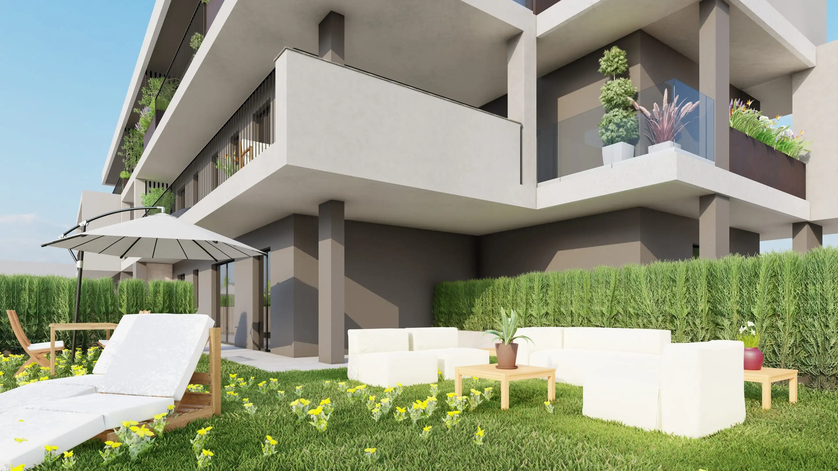Residenza Modigliani a Cornate d’Adda: giardino al piano terra con divanetti, lettino e ombrellone